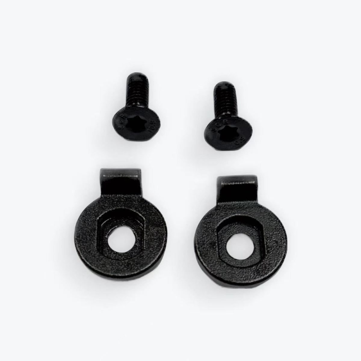 Set of black metal screws and washers on a white background