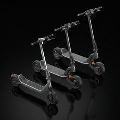 Two grey electric scooters positioned side-by-side against a black background.